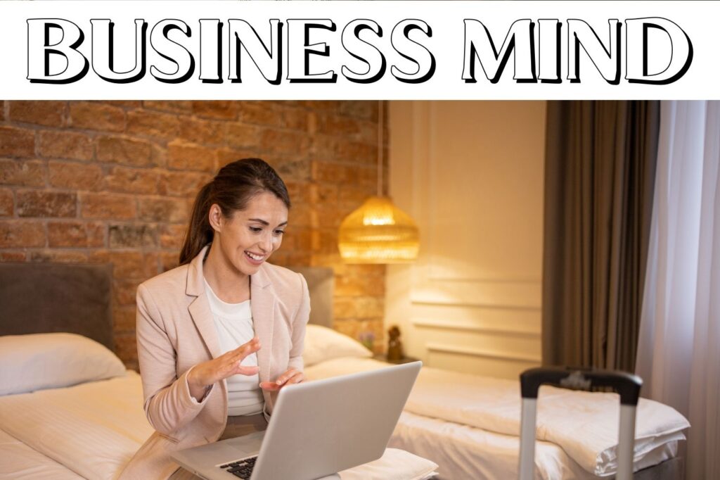 ‘Business Mind’ written in BeePop Luxury Shadow Font with a woman working on a laptop in a cozy room.